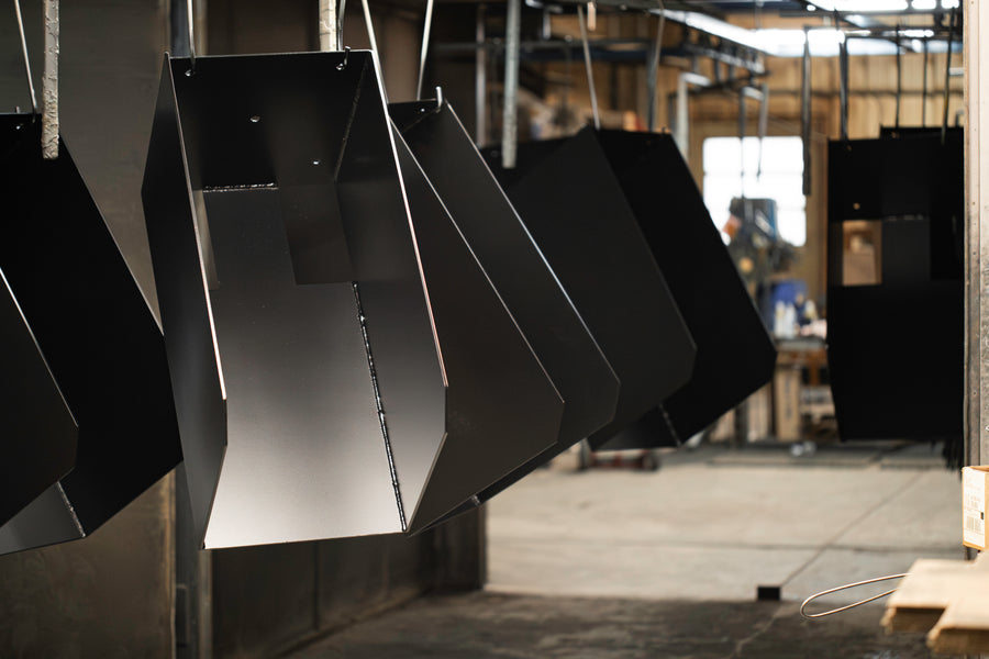Sheet metal parts hanging on the powder coating line